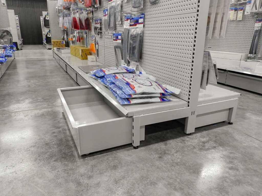 Retail display shelving with pull-out storage drawer